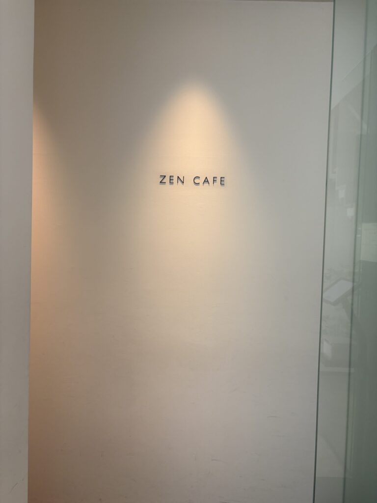 祇園ZEN CAFEの入口。白い壁に小さくロゴだけが浮かぶ
