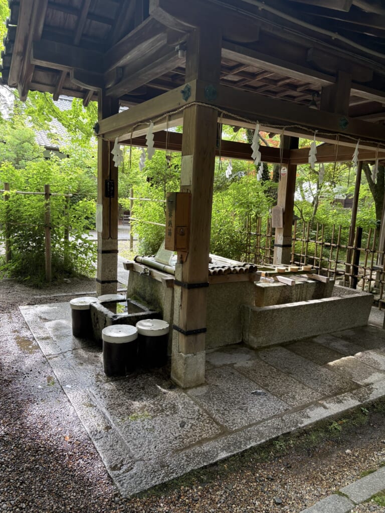 手水舎と丸い腰掛け（今の写真3とほぼ同じ構図。こちらは明るく、地面が濡れています）
